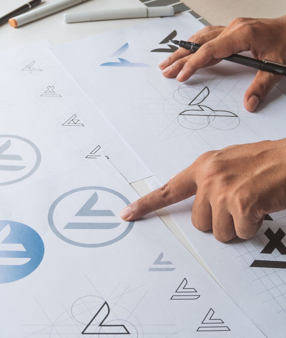 Creative designer pointing to logo concepts